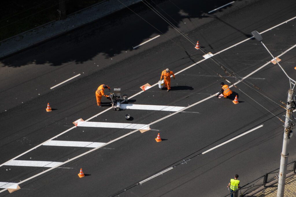 a group of construction workers working on a road.