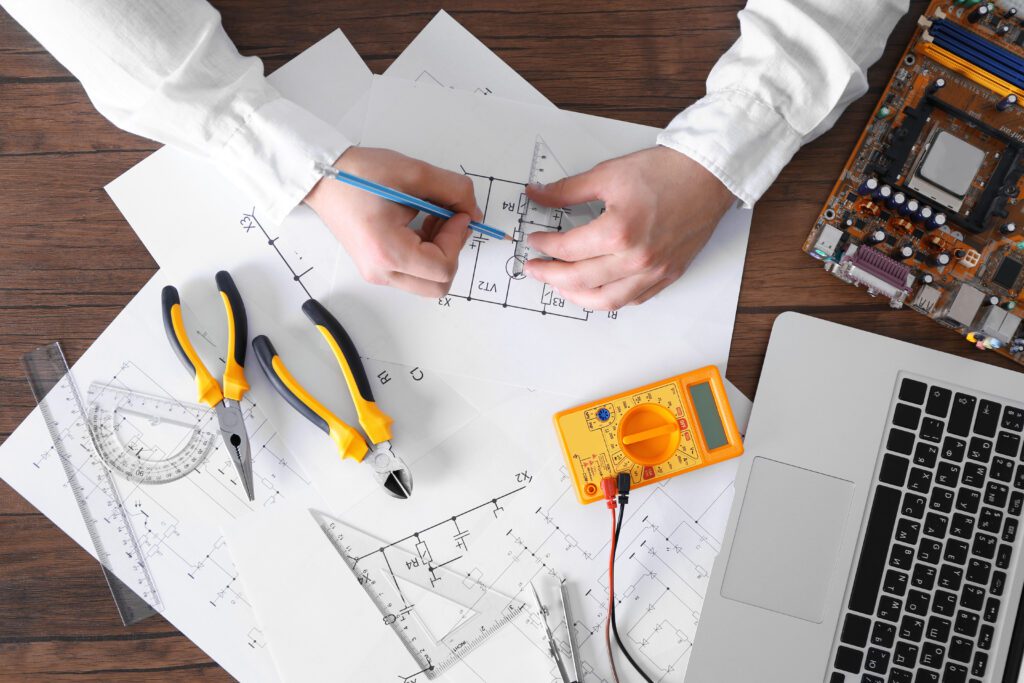 a man is working on a laptop with a drawing on it.