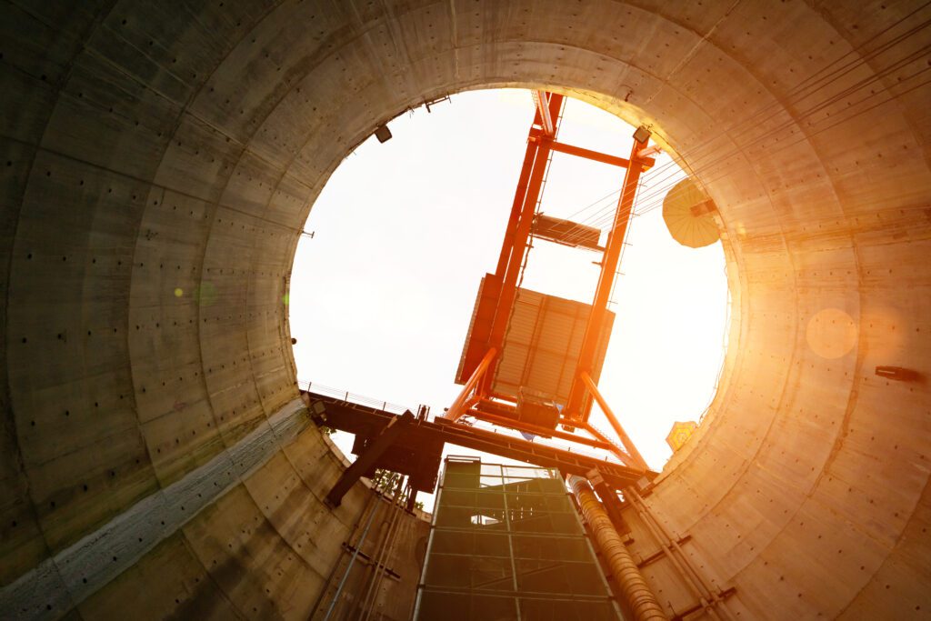 an image of a construction crane in a concrete tunnel.